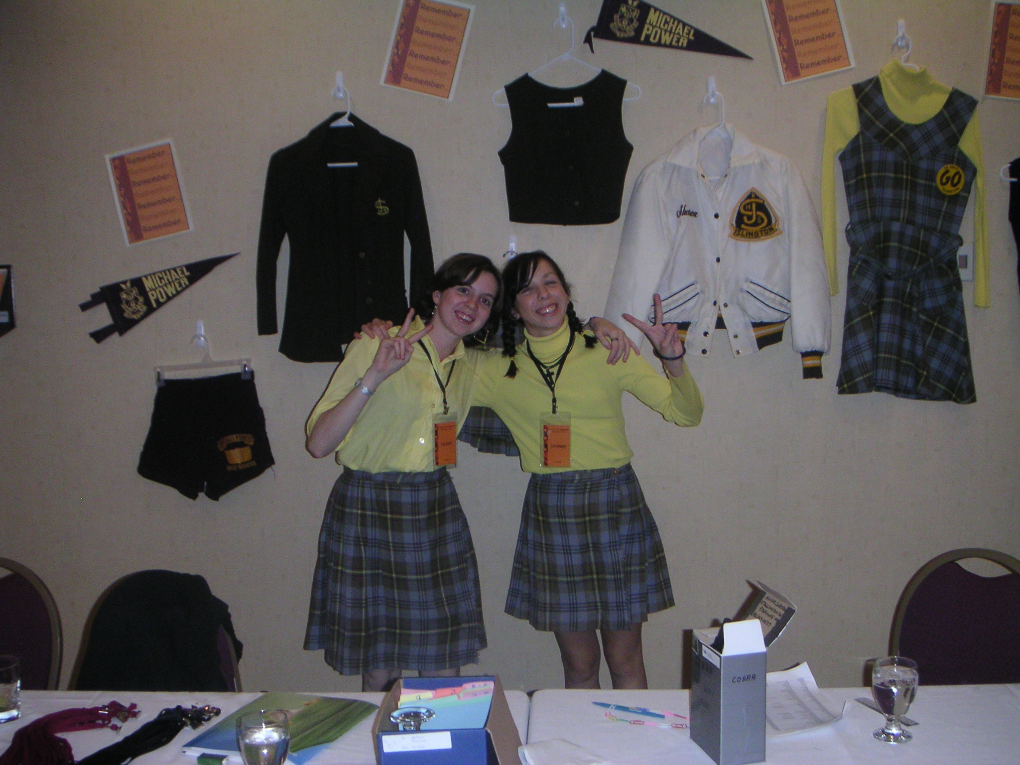 Lauren and Lindsy model the old uniform. Behind them are more original high school fashions.